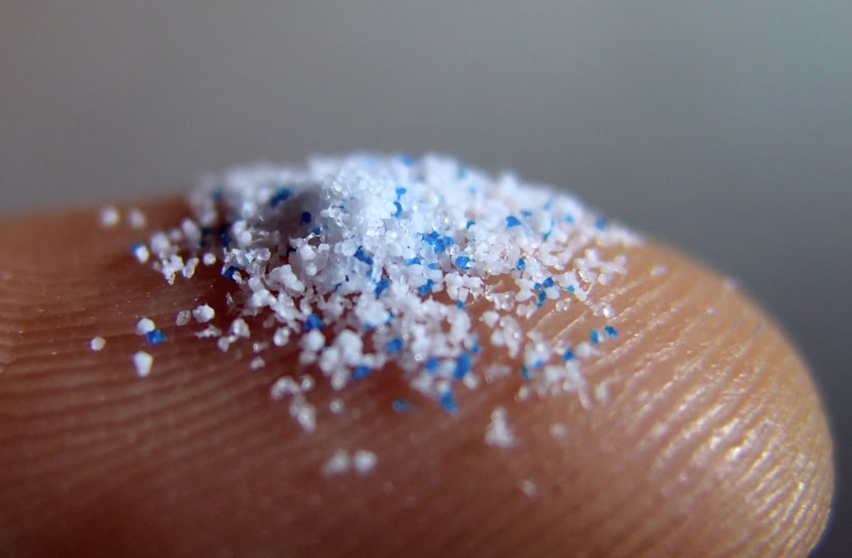 Microplastics are incredibly small particles of plastic that come from products like packaging, clothing, and industrial waste.
