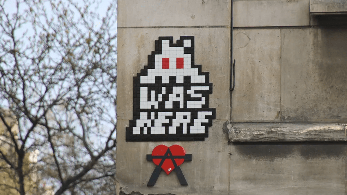 Invader's signature mosaic tile installation blends 8-bit nostalgia with radical public art ideals.