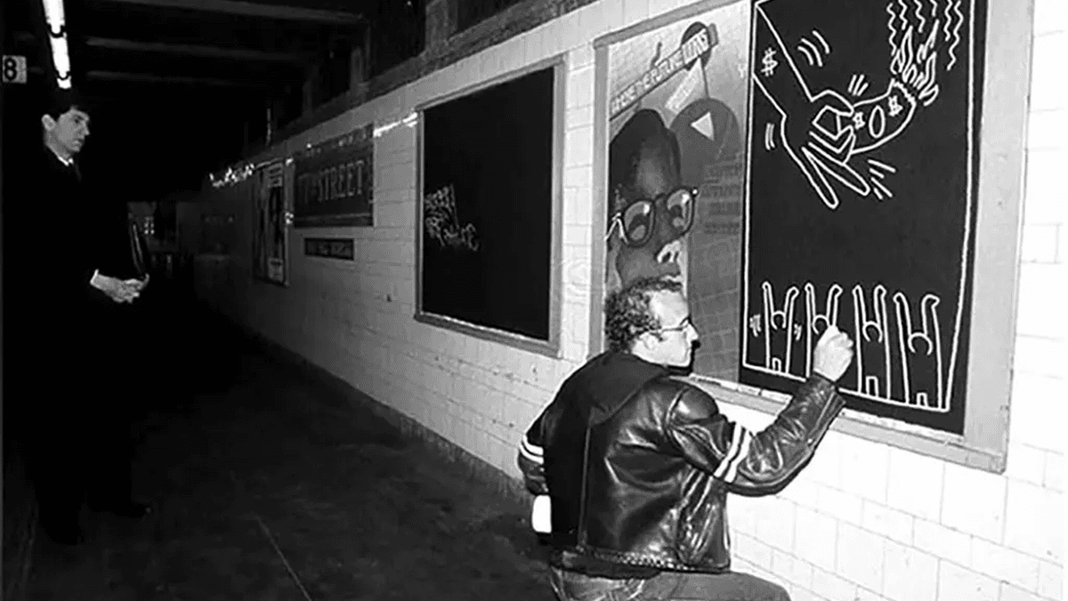 Keith Haring’s subway chalk drawing showing his iconic cartoon-like figures full of life and movement.