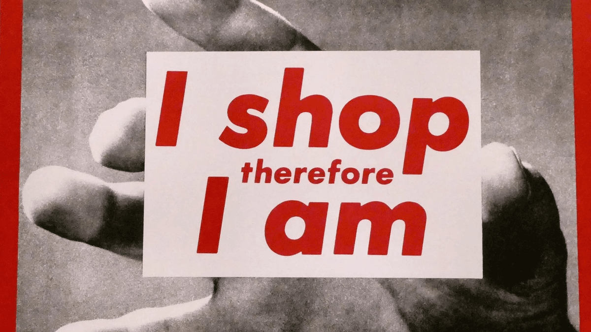 Barbara Kruger's bold white-on-red text over a black-and-white photo