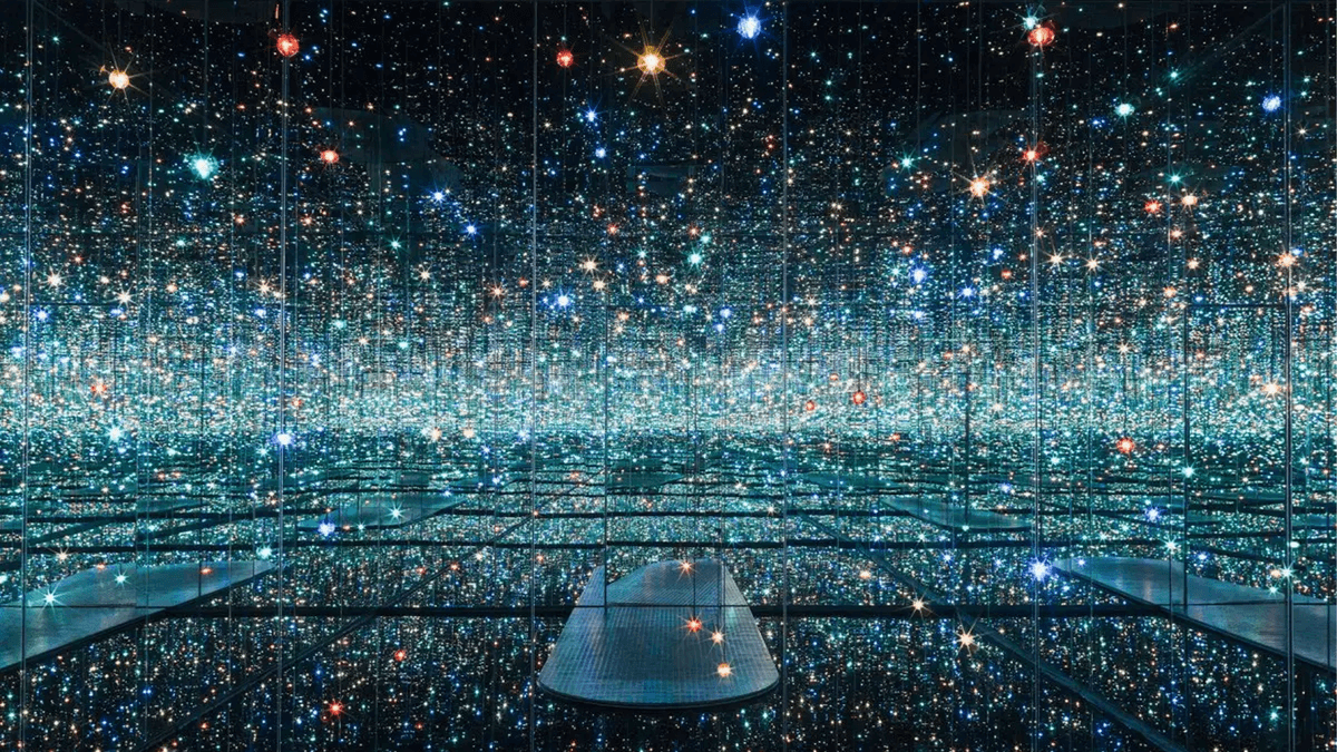 Yayoi Kusama’s Infinity Mirror Room with bright lights reflecting endlessly, featuring her signature polka dot pattern.