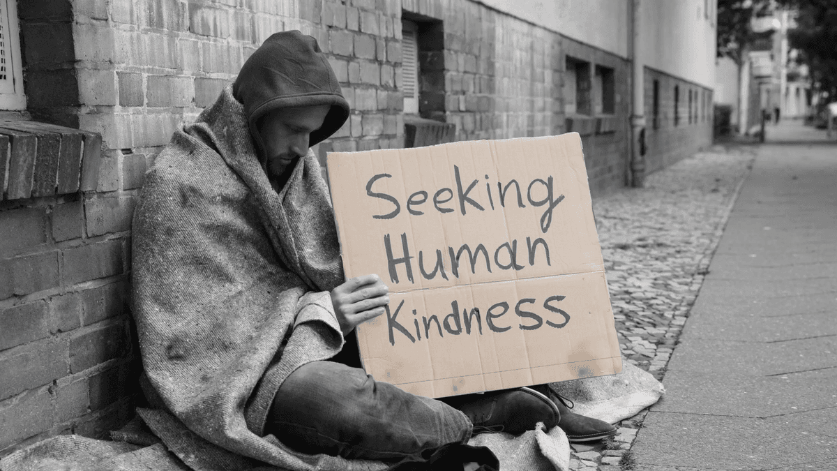 Empty hallway of an abandoned psychiatric hospital with sunlight coming through broken windows.