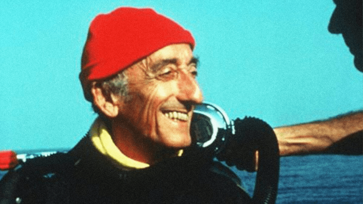 Jacques Cousteau wearing his iconic red cap aboard a ship